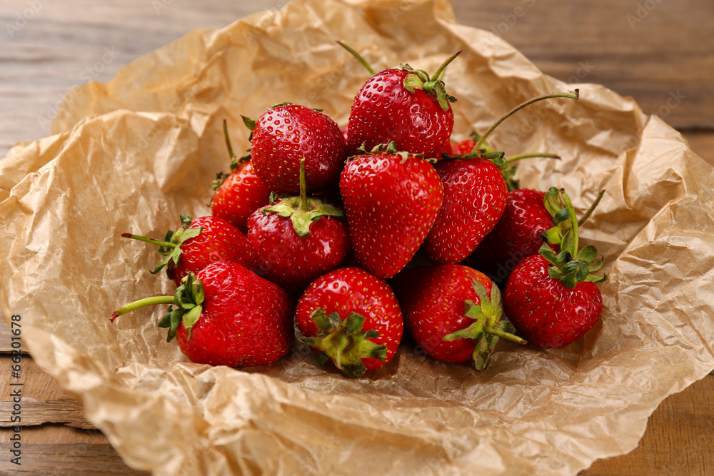 Red ripe strawberries with chocolate on wooden table