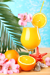 Wall Mural - Refreshing orange cocktail on beach table