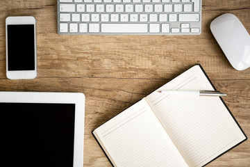 notebook wit tablet on wooden table