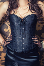 Woman Wearing Black Corset And Pearls Against Retro Background