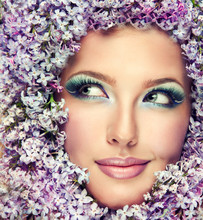 Funny Beautiful Model In Flowers Lilac Sly Looks In The Side.