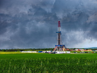 Wall Mural - Natural gas drilling worksite with dramatic sky.