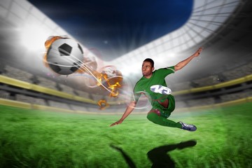 Poster - Composite image of football player in green kicking