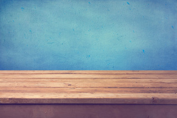 Wall Mural - Empty wooden deck table over blue painted wall