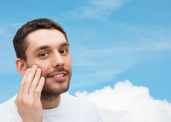 Poster - beautiful smiling man touching his face