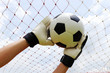 © kungverylucky - goalkeeper's hands reaching for foot ball
