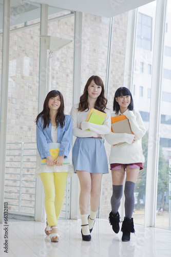 ノートを持って3人並んで歩く女子学生 Stock 写真 Adobe Stock