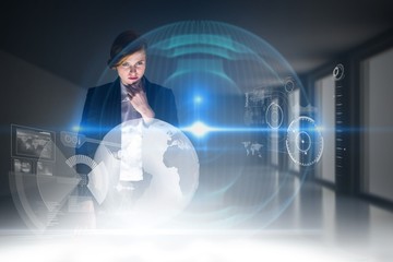 Leinwandbilder - Composite image of redhead businesswoman using interactive desk