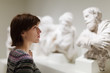  woman looking ancient sculptures