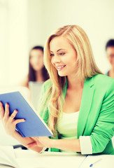 Poster - smiling young girl reading book at school