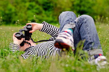 Little boy observing the sky through binoculars