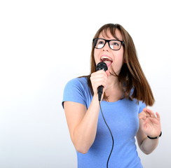 Portrait of a young female with microphone against white backgro