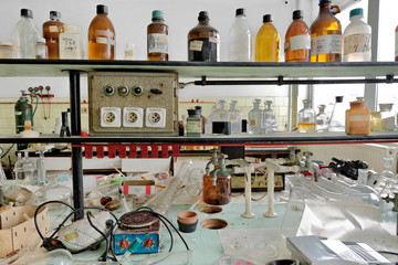 Photo of an old laboratory with a lot of bottles