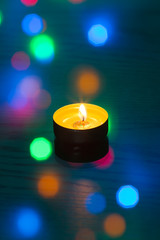 burning tea candle on the table