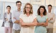 © WavebreakmediaMicro - Casual business team smiling at camera with arms crossed