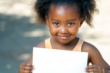 african girl holding white card.
