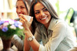 © Drobot Dean - Cheerful businesswoman holding cup of coffee