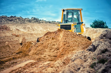Industrial Bulldozer And Excavator Working With Earth In Sandpit