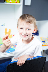 Boy holding colorful letters