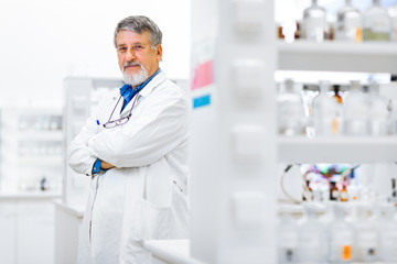 Wall Mural - Senior male researcher carrying out scientific research in a lab