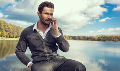 Wall Mural - Handsome man talking on a smartphone