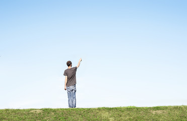 young man pointing to the sky