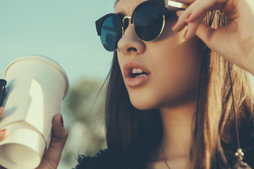 Beautiful hipster woman with cup of coffee