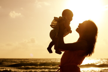 portrait of happy loving mother and her baby outdoors
