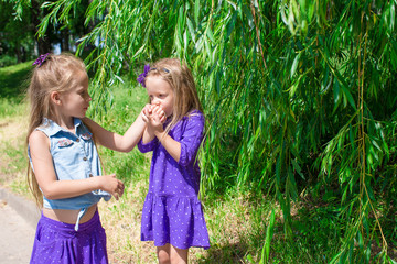 Wall Mural - Happy adorable little girls enjoy summer day in the park