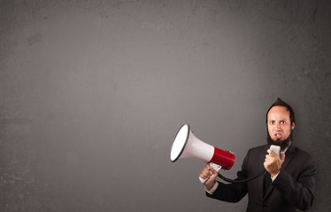 Guy shouting into megaphone on copy space background