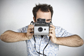 Tourist taking a picture with vintage camera