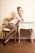 © Voyagerix - Vintage style. Girl sitting at the retro desk.