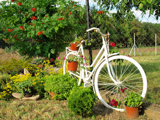 Poster - Model of an old bicycle equipped with basket of flowers