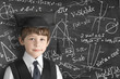 © Natalia Merzlyakova - boy near blackboard with formulas