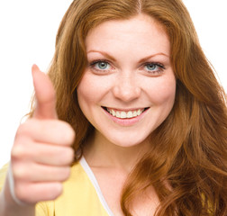 Woman is showing thumb up gesture