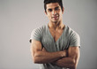 © Jacob Lund - Muscular young man standing with his arms crossed