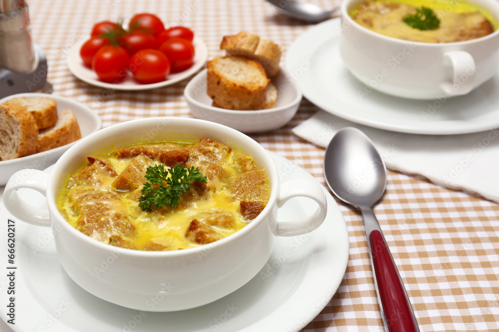 Tasty soup in saucepans on tablecloth, close up