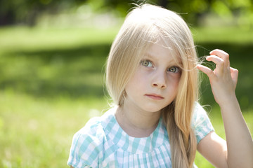 Portrait of a beautiful blonde little girl three years