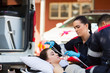 © michaeljung - female EMT putting oxygen mask on patient