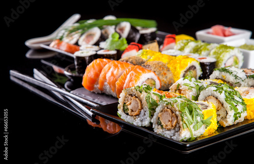 Fotoboard na płycie Pyszne kawałki sushi na czarnym tle
