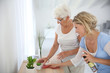 © goodluz - Housekeeper cleaning elderly woman's home