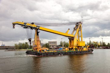 Heavy floating crane in the port.