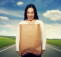 Wall Mural - woman looking into the paper bag