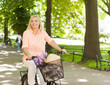 Happy beautiful woman riding a bike at park