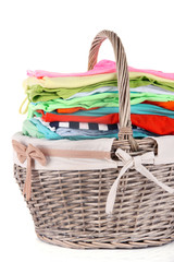 Wall Mural - Bright clothes in laundry basket, isolated on white