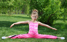Little Girl In Pink Performs Exercise Splitting Legs Apart