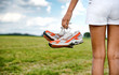 © XtravaganT - Young girl in shorts holding her sneakers