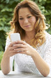 Attractive Teenage Girl Sending Text Message On Phone