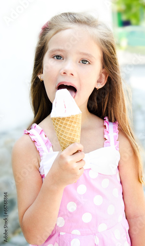 Cute little girl eating ice cream Stock Photo | Adobe Stock