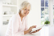© Monkey Business - Senior woman using tablet at home